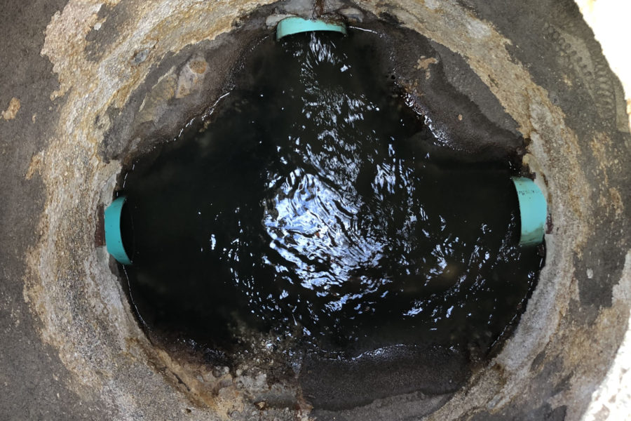 Deteriorated manhole bench and exposed substrate in Charlotte County, Florida before SewperCoat® rehabilitation