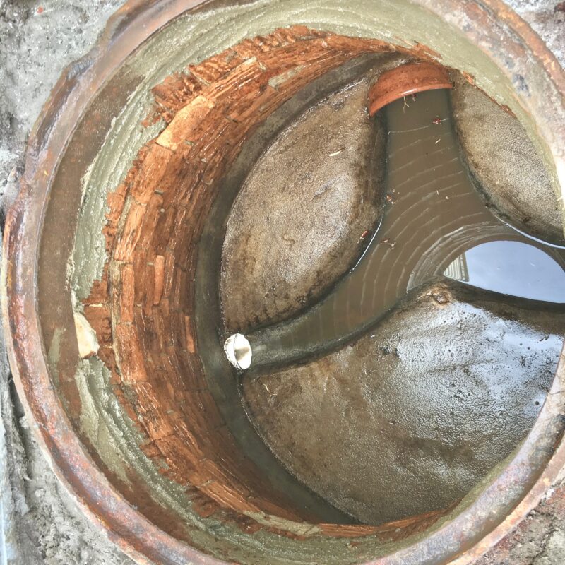 Brick manhole during rehabilitation after root removal and groundwater infiltration control
